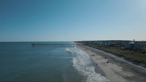 rolling waves along kure beach shoreline 4k aerial