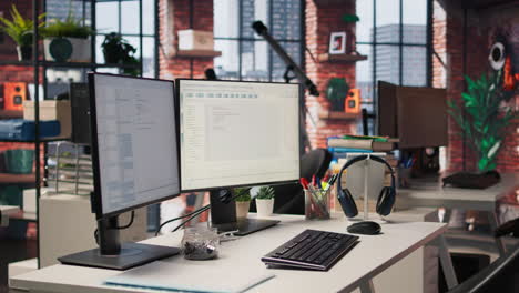 coding platform on pc screens in empty silicon valley startup office