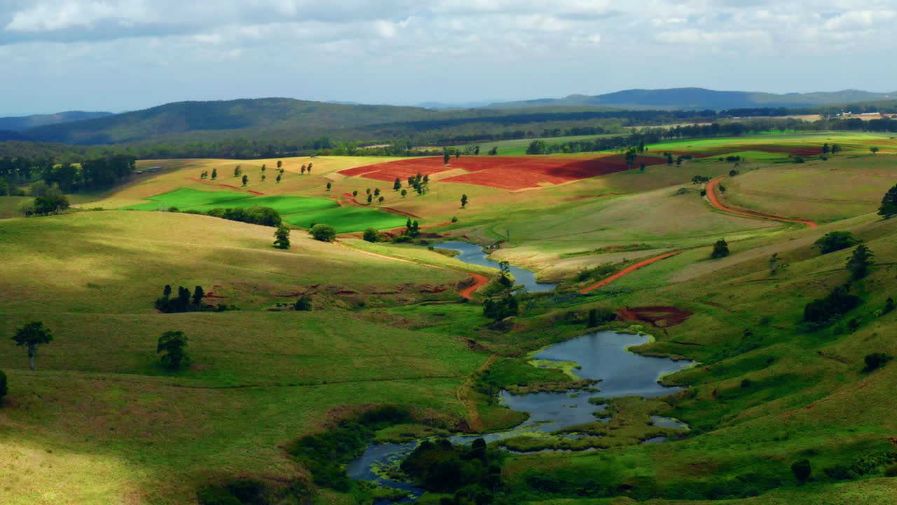 Landscape Of Colorful Fields And Creeks In Atherton Tablelands Region, Queensland, Australia - aerial drone shot