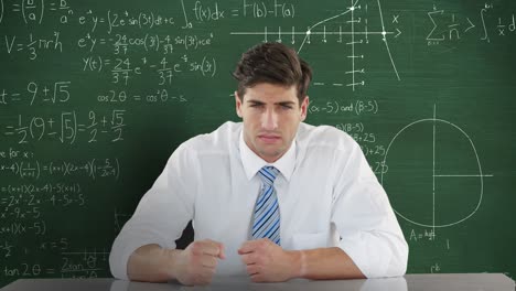 Man-in-front-of-moving-maths-on-blackboard