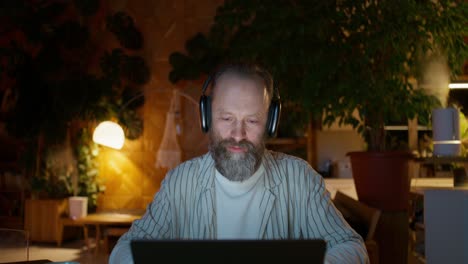 man in headphones having a video call at home