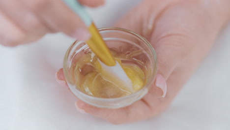 applying a golden face mask