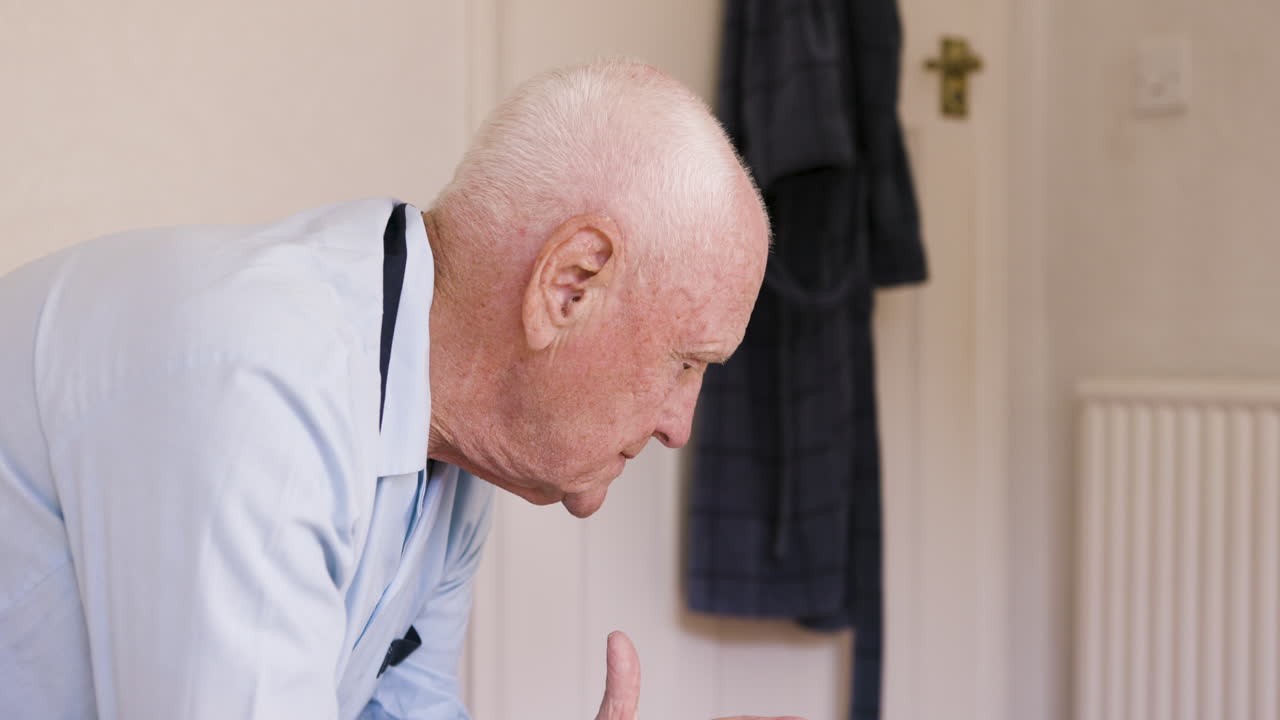 An elderly man is pensive