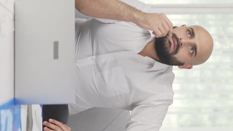 vertical video of home office worker man thinking creatively.