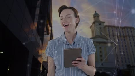 Animation-of-caucasian-businesswoman-using-tablet-and-network-of-connections-over-cityscape