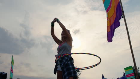 girl hula-hooping at a music festival, slow motion