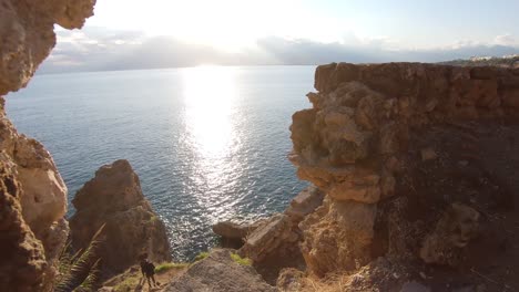 walk through shot capturing rocky cliffs and sun kissed sea in antalya turkey