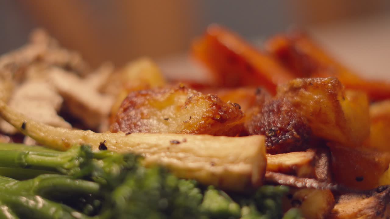 Moving View Over British Roast Lunch with Close Up Details Broccoli, Parnsips, Golden Potatoes. Classic British Cuisine Food