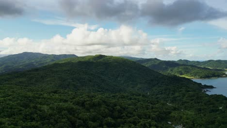 panoramic aerial drone shot of lush tropical mountains and cloudscape at island province catanduanes, philippines