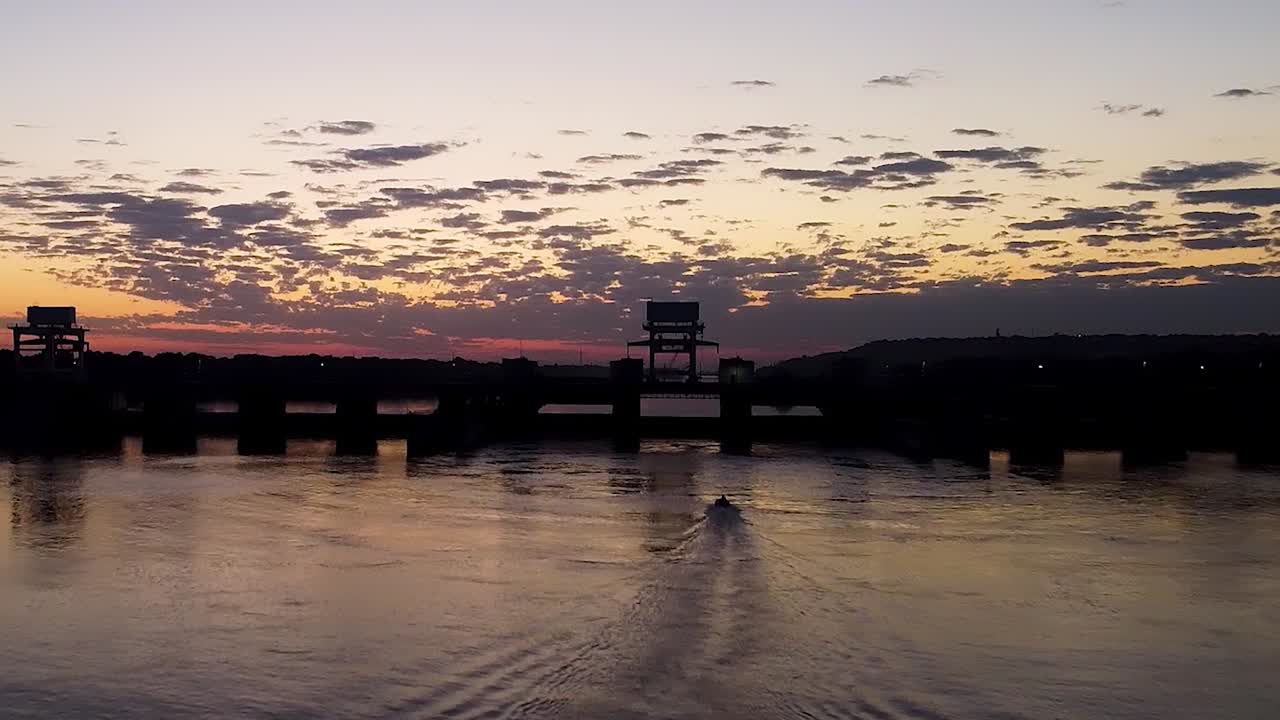 Sunrise over a River Dam with Boat