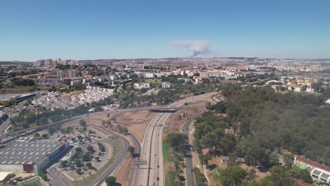 drone view of the lisbon city fire event from a distance, visible clouds of smoke