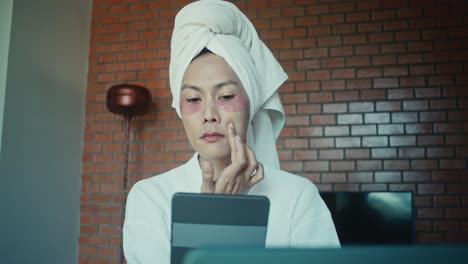 woman applying eye and face masks