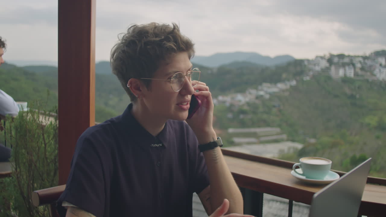 Businesswoman Having Phone Talk in Cafe with Mountain View