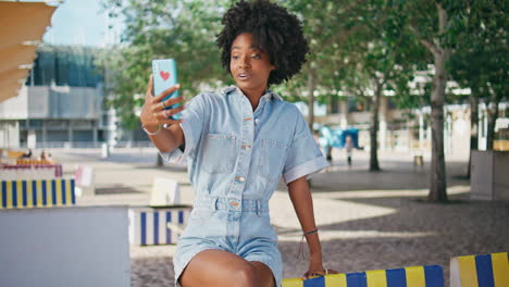 young woman taking selfie in a city park