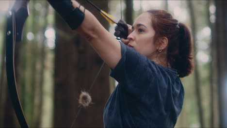 archery woman pulls her bow medium close shot