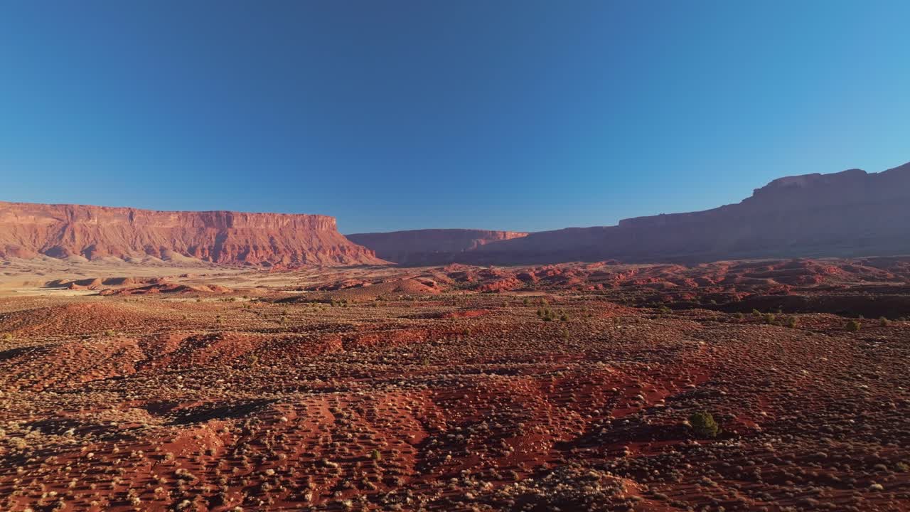 Aerial drone of Moab rugged canyons, immense geological formations and deep valleys under blue sky
