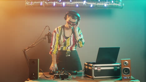 female disc jockey producing techno music at mixer