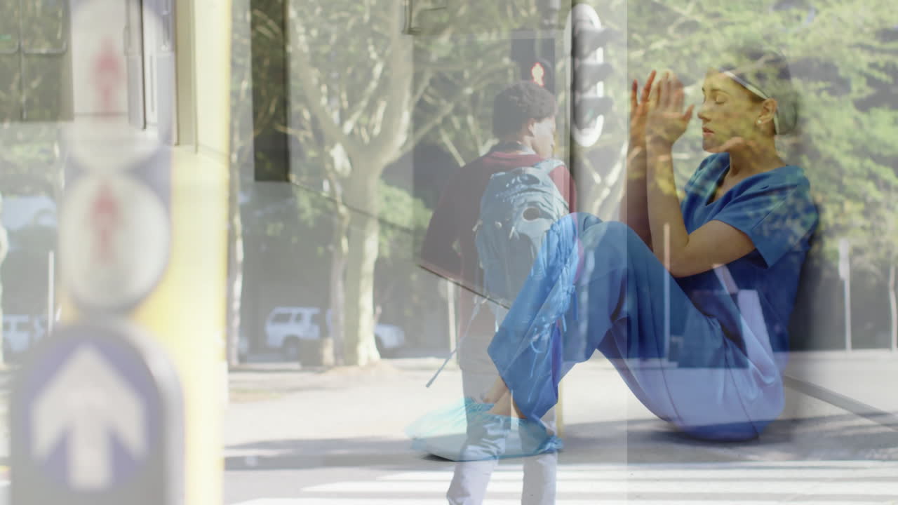 Healthcare worker in scrubs sitting with urban street scene animation overlay