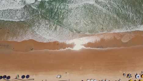 topdown upwards waves crashing at beach shore, natal, brazilian coastline