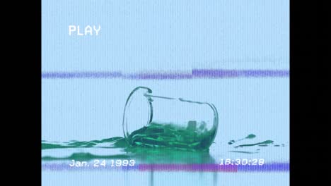 animation of screen with glitch over falling glass with green reagent