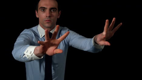 Businessman-throwing-basketball-to-camera-on-black-background