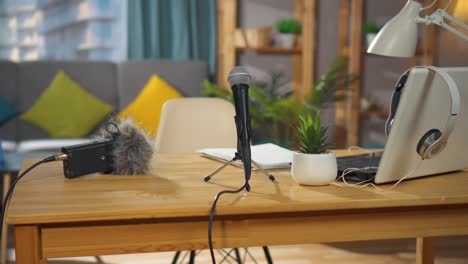 close up of a microphone on a desk in a home recording studio,nobody