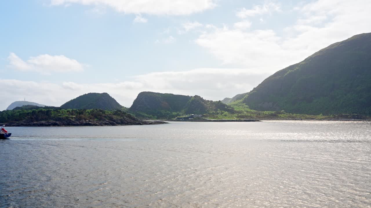 A cruise along the coast of Norway cargo ship is passing by on a voyage