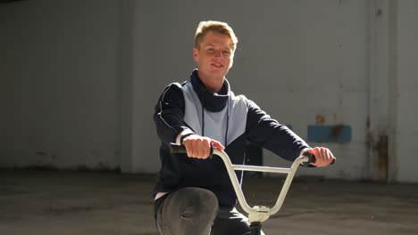 bmx rider in an empty warehouse