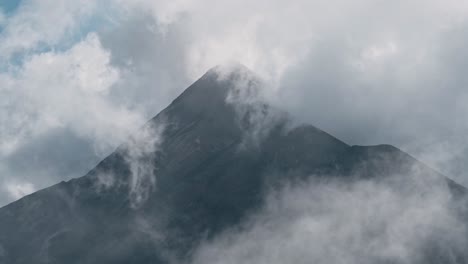 clouds reveal high peak of volcano mountain in guatemala, handheld view