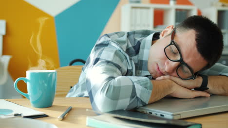tired employee taking a nap at work