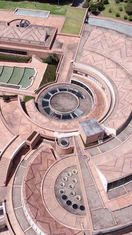 vertical drone shot, modern architecture of bogota, colombia, virgilio barco library building in simon bolivar park