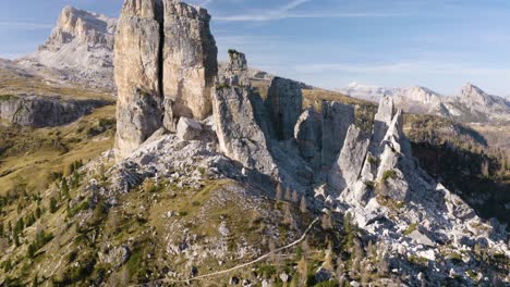 cinematic drone shot reveals cinque torri mountains in italian dolomites