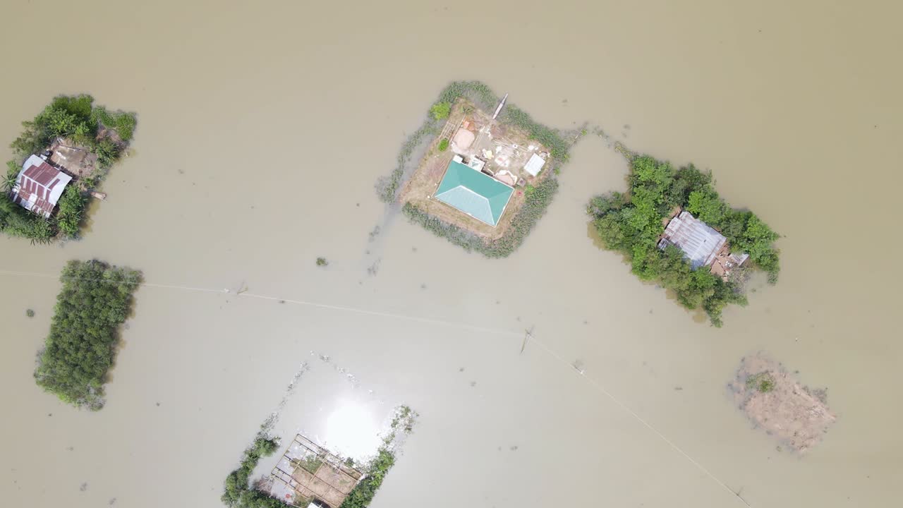 Rural flooded village. Homes surrounded by flood water. Bangladesh. Aerial top view