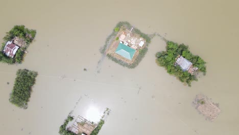 rural flooded village. homes surrounded by flood water. bangladesh. aerial top view