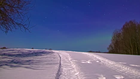 Ethereal-Aurora-Borealis-Lights-Above-Snow-Covered-Hill-In-Twilight-Evening-Skies