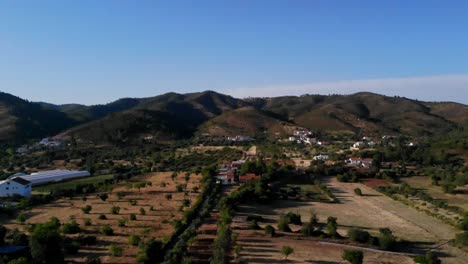 drone shot of some fields and mountains in salir, algarve, portugal.