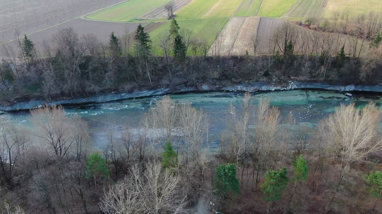 Savinja River near Vrbje Slovenia farm fields seen from above, Aerial flyover look down shot