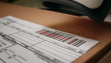 Scanner scan delivery box in storage, E-commerce shop, man packing goods and clothes second hand delivery market, courier Packaging and Shipping Workspace with Supplies and Technology, online sales.