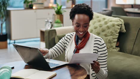 woman working from home with laptop and paperwork