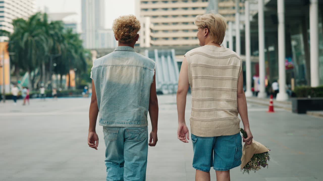 Two men holding hands in the city