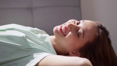 a woman enjoys a moment of relaxation radiating happiness in her serene home setting.