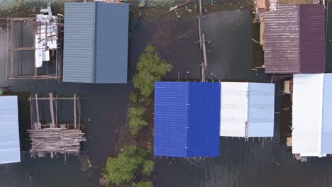 aerial view of houses on stilts in a flooded area