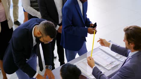 Business people checking in at conference registration table 4k