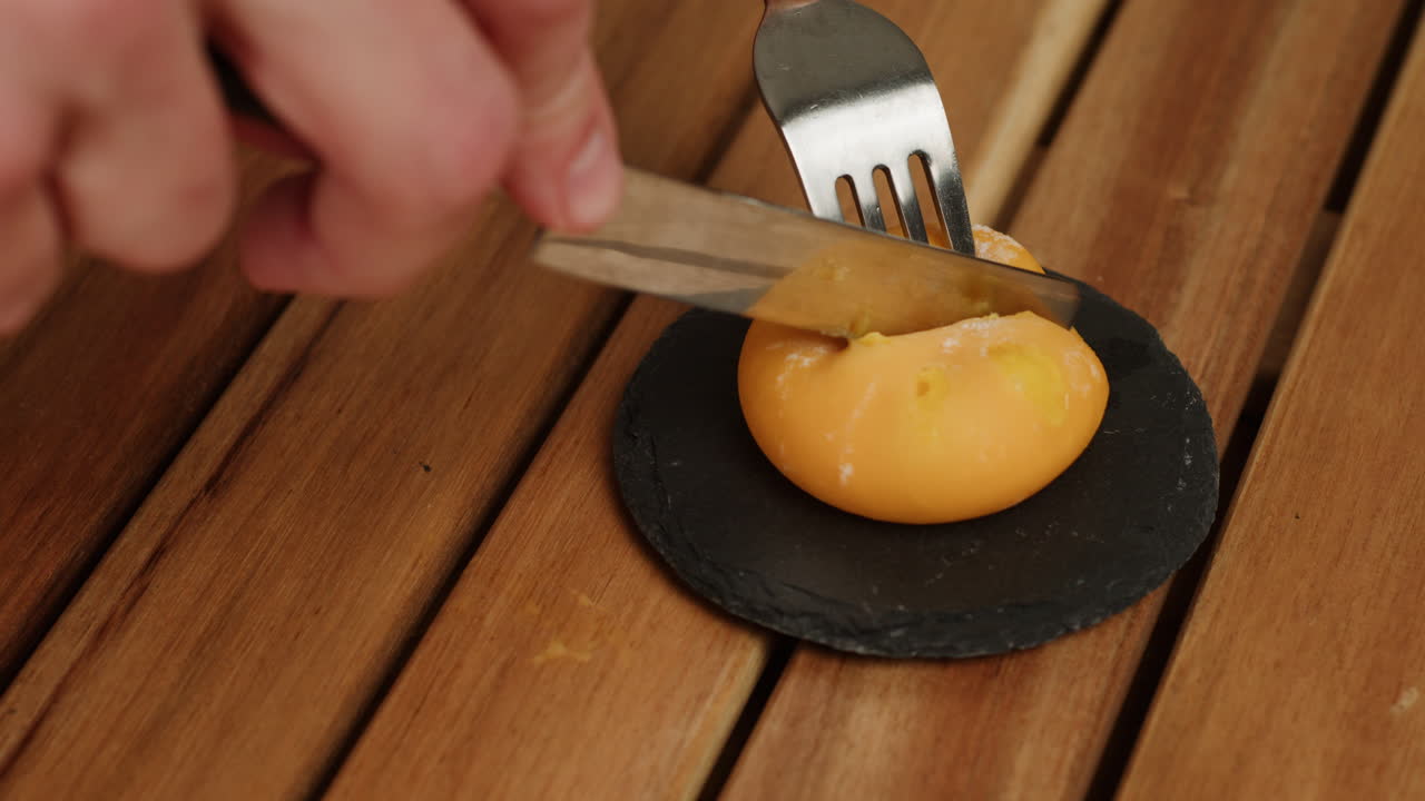 Cutting a round orange dessert