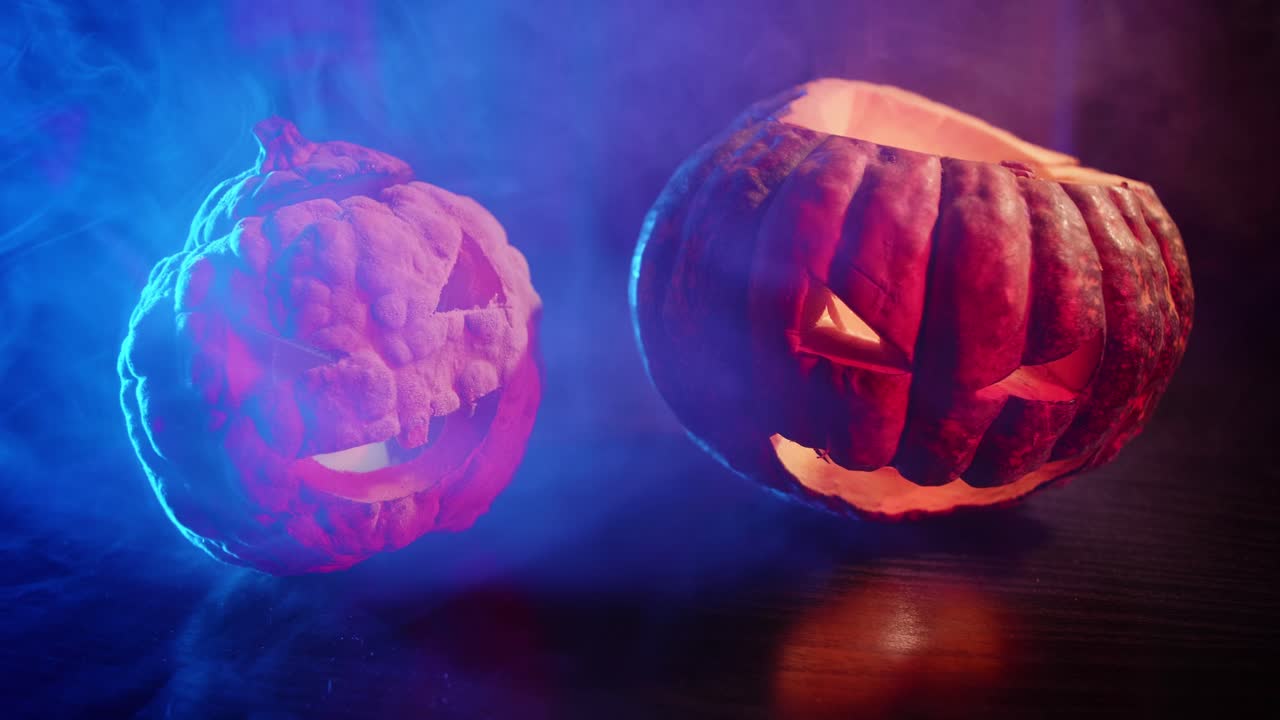 Two Glowing Jack-o'-Lanterns in Smoky Blue and Red Light