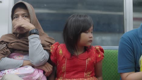 woman and child riding on public transport