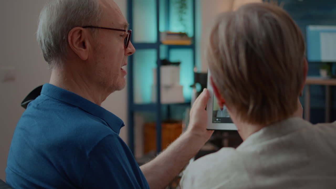 Elderly couple on video call with grandchild