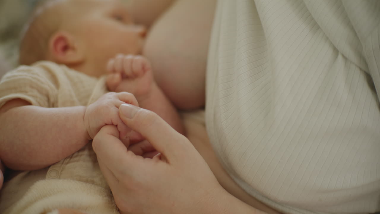 A mother breastfeeding her newborn baby