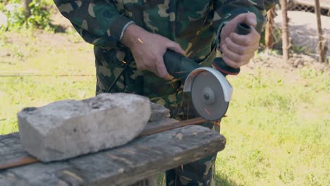 close view repairman cuts piece of metal with circular saw