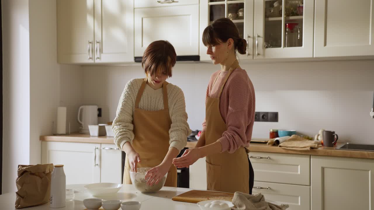 Mother and daughter cooking in kitchen